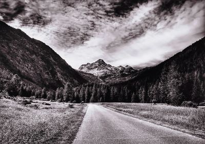 Road amidst mountains against sky