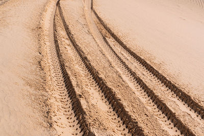 Full frame shot of tire tracks on desert land