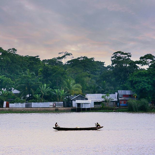 tree, sky, cloud - sky, building exterior, architecture, built structure, nautical vessel, water, transportation, cloud, mode of transport, tranquil scene, cloudy, tranquility, nature, boat, waterfront, scenics, beauty in nature