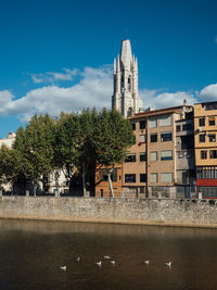 View of canal by buildings against sky