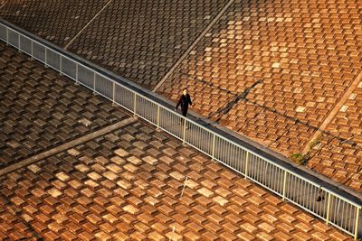 Shadow of person on cobblestone