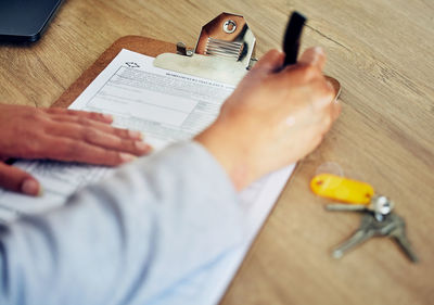 Cropped hands of man working on table