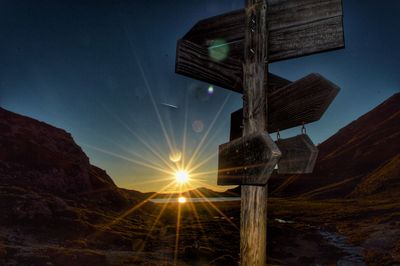 Low angle view of illuminated built structure against sky during sunset