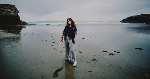 Full length of young woman on beach