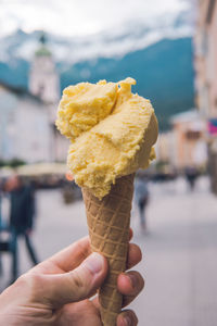 Cropped hand holding ice cream cone