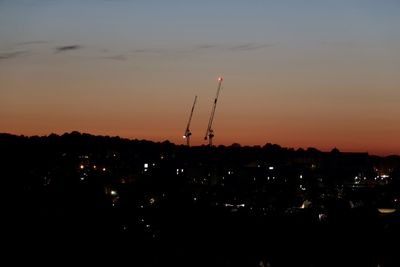 Silhouette buildings against sky during sunset