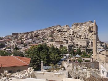 Buildings in town against clear blue sky