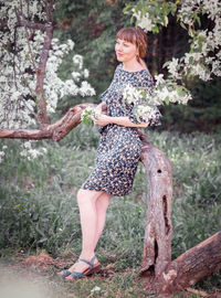 Young woman portrait on the blooming apple trees background