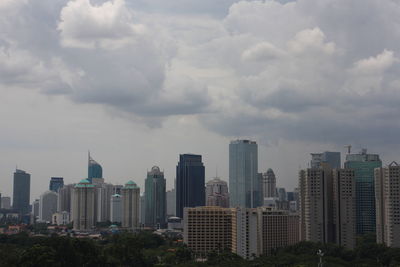 High angle view of buildings against clouds