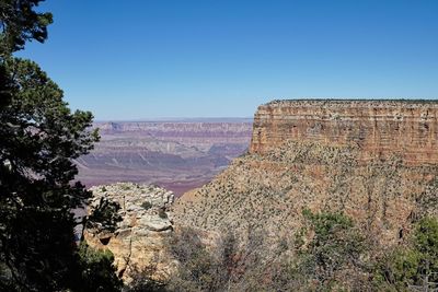 Scenic view of rocky mountain against blue sky