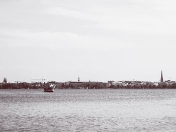 Sailboats in sea against sky