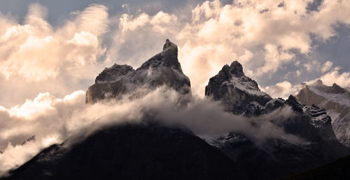 Panoramic view of majestic mountains against sky during sunset