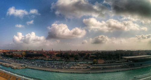 View of cityscape against cloudy sky