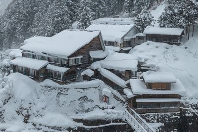 Snow covered houses and buildings in city