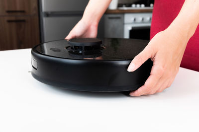 Cropped hand of person using equipment on table