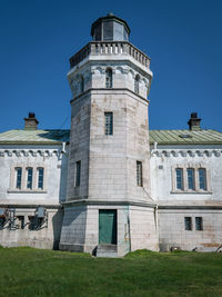 Low angle view of lighthouse building against blue sky