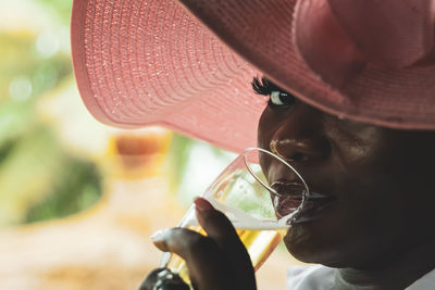 African woman drinking beer at restaurant in axim ghana west africa