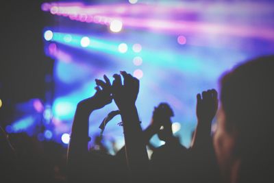 Crowd with arms raised in music concert