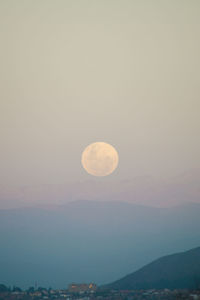 Scenic view of moon against sky at sunset