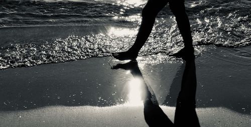 Low section of woman in sea