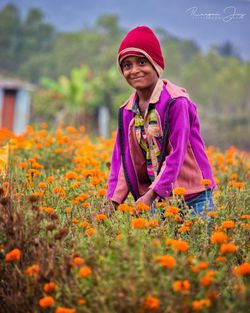 Portrait of girl standing on field