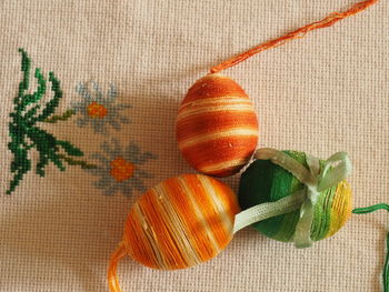 Close-up of easter eggs wrapped in threads on table