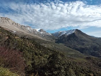 Scenic view of tikejda mountains against cloudy sky