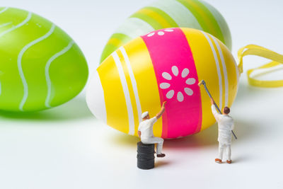 Close-up of multi colored balloons against white background