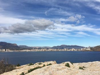 View of rock formation at sea against sky