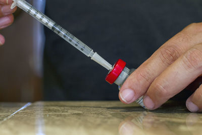 Midsection of person holding hands on table