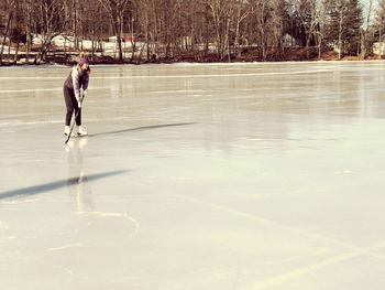 Pre-adolescent girl playing ice hockey