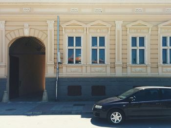 Car on street against building in city