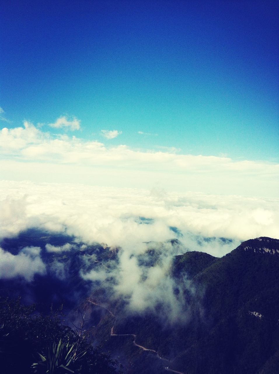 scenics, beauty in nature, tranquil scene, blue, sky, tranquility, aerial view, nature, mountain, landscape, cloud - sky, idyllic, cloud, majestic, mountain range, cloudscape, copy space, no people, outdoors, day