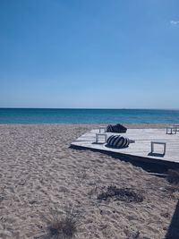 Scenic view of beach against clear blue sky