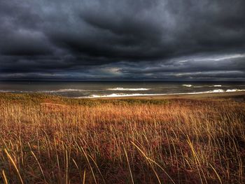 Scenic view of sea against cloudy sky