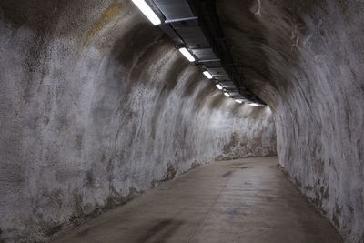 Walkway in illuminated tunnel