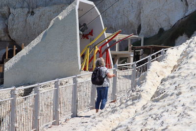 Rear view of a woman walking on snow