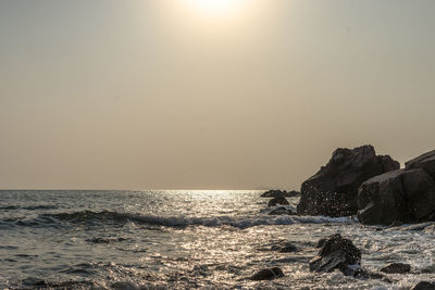 Man surfing in sea against clear sky