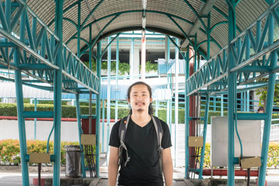 Portrait of young man standing in corridor