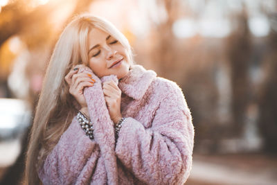 Beautiful woman wearing warm clothing at park