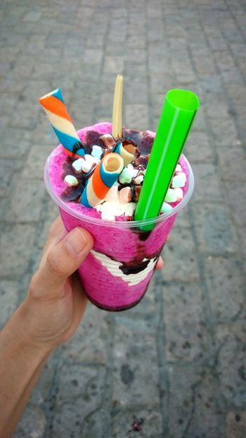 Cropped hand holding smoothie drink