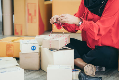 Midsection of woman holding toy while sitting on table