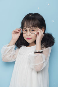 Portrait of woman against white background