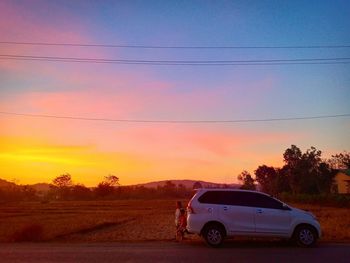 Scenic view of field against sky during sunset