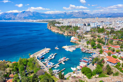 High angle view of townscape by sea against sky