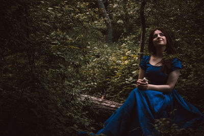 Portrait of young woman in forest