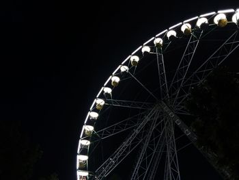 Low angle view of ferris wheel against sky at night