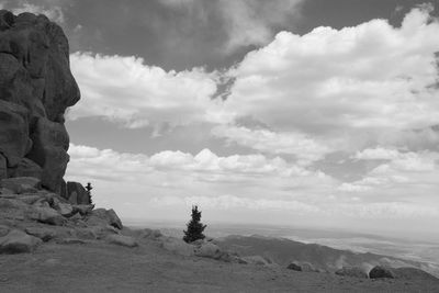View of rocky landscape against cloudy sky