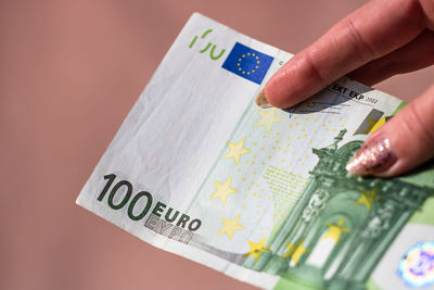 Close-up of hand holding paper