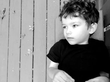 Close-up of boy playing with door